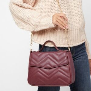Summer & Rose purse burgundy with gold chain accent.